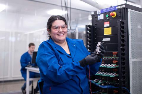 engineering student smiling in lab in goggles