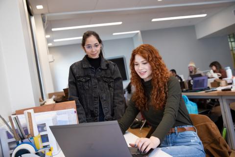 students looking at computer in architecture lab