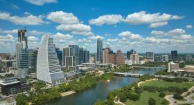 Image depicts the Austin city skyline on a sunny day.