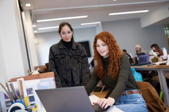 students looking at computer in architecture lab