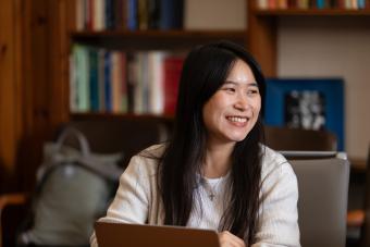 woman smiling in front of laptop