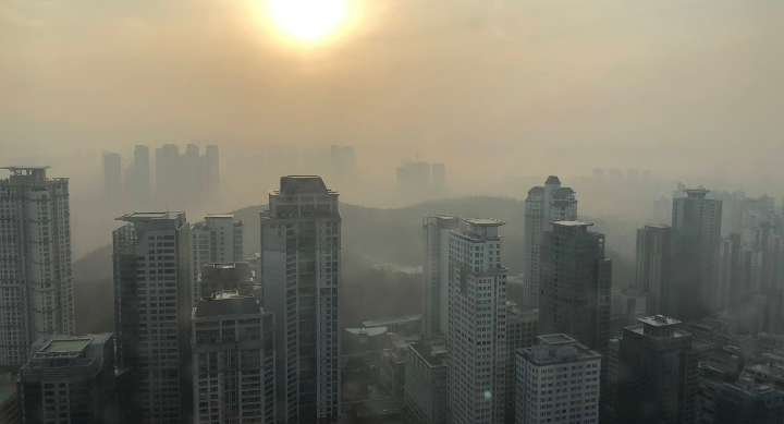 A city skyline covered with thick smog.